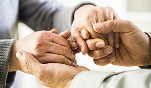 Hands reaching out between two people and clasping each other Golden Leaves