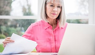 Senior business lady working through papers