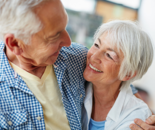 Senior couple laughing and embracing best prepaid funeral plans