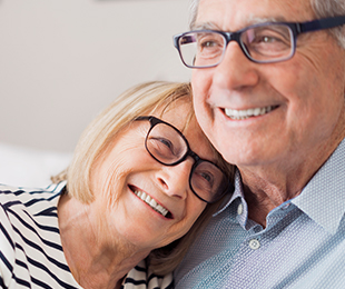 happy senior couple in matching eyeglasses