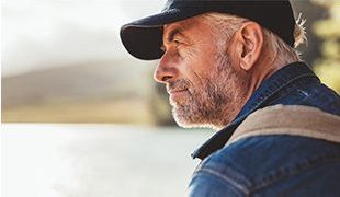 Man looking into distance across a lake Golden Leaves