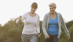 two middle aged woman happily hiking funeral plans