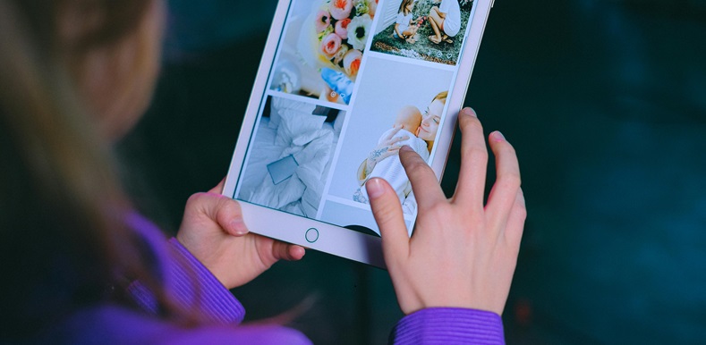 Woman looking at photo album on tablet
