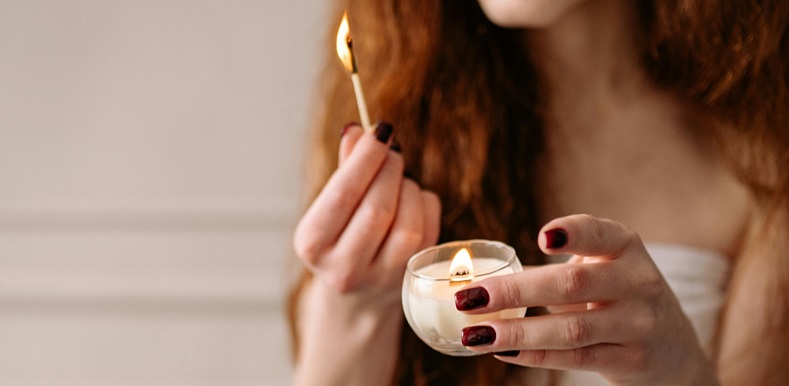 Woman lighting a candle