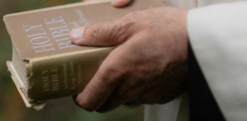 Priest holding Bible