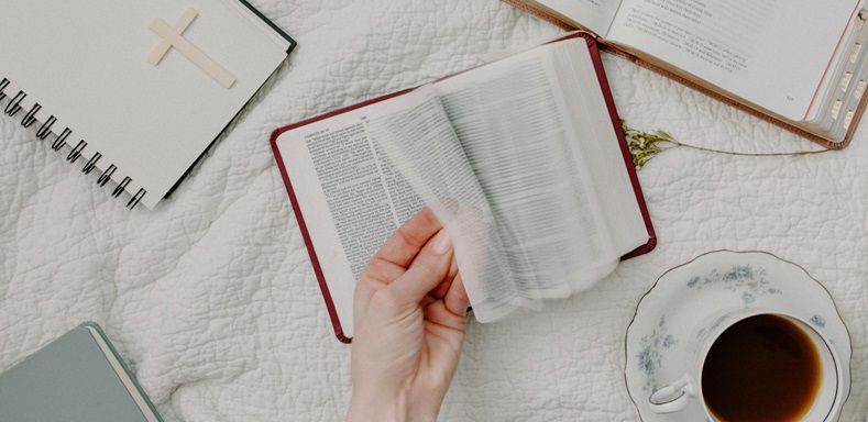 Person flipping through Bible