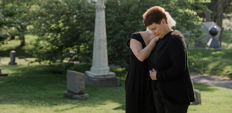 Elderly Woman Grieving at a Cemetery