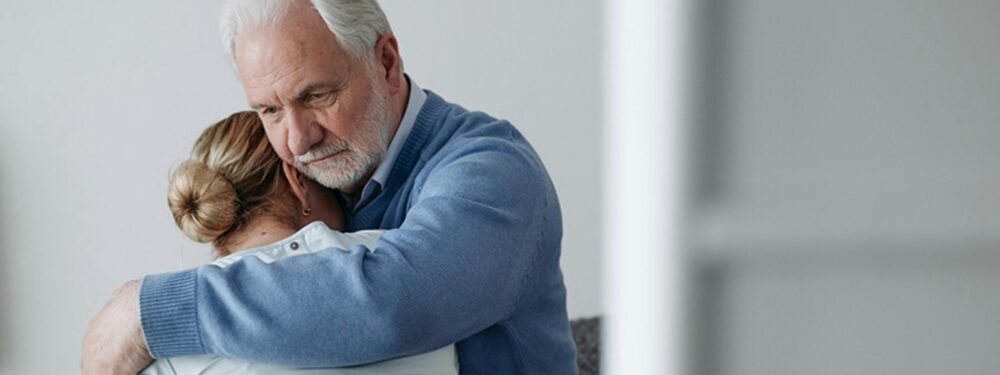 Elderly Couple Consoling Each Other