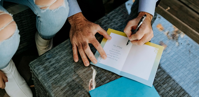 Photo Of Man Writing On A Paper