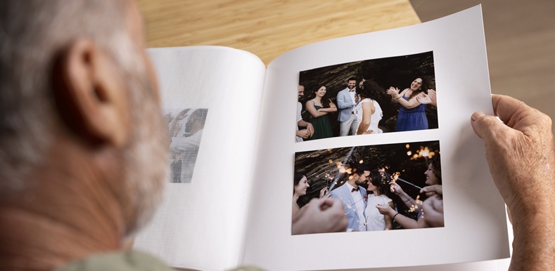 high-angle-man-looking-picture-album