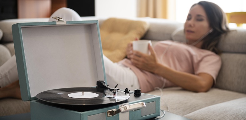 woman-relaxing-home-while-listening-vinyl-music