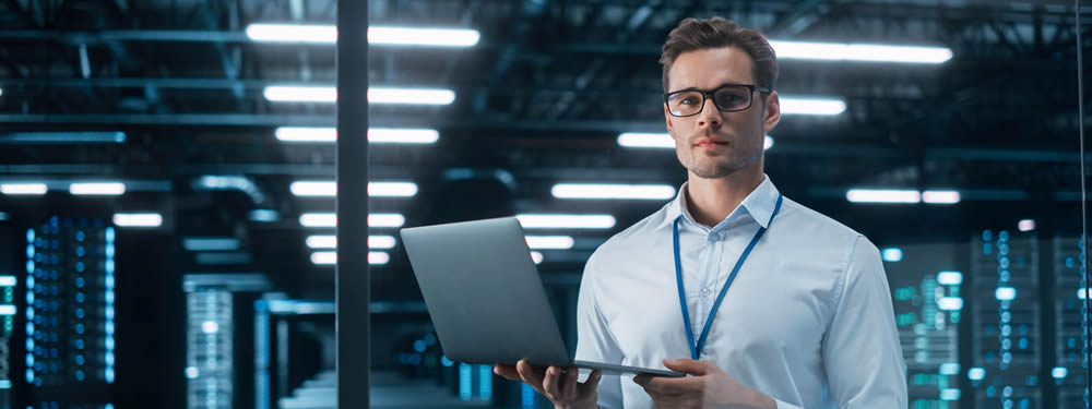 Man using laptop and managing the server room